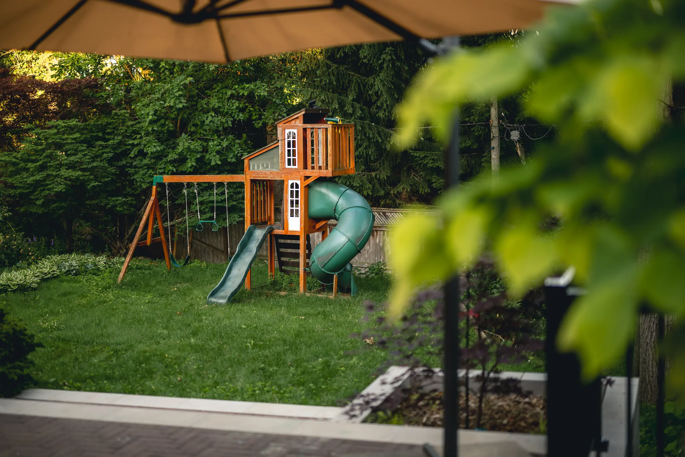 Etobicoke backyard transformation with wood deck, boardwalk, and raised planting bed