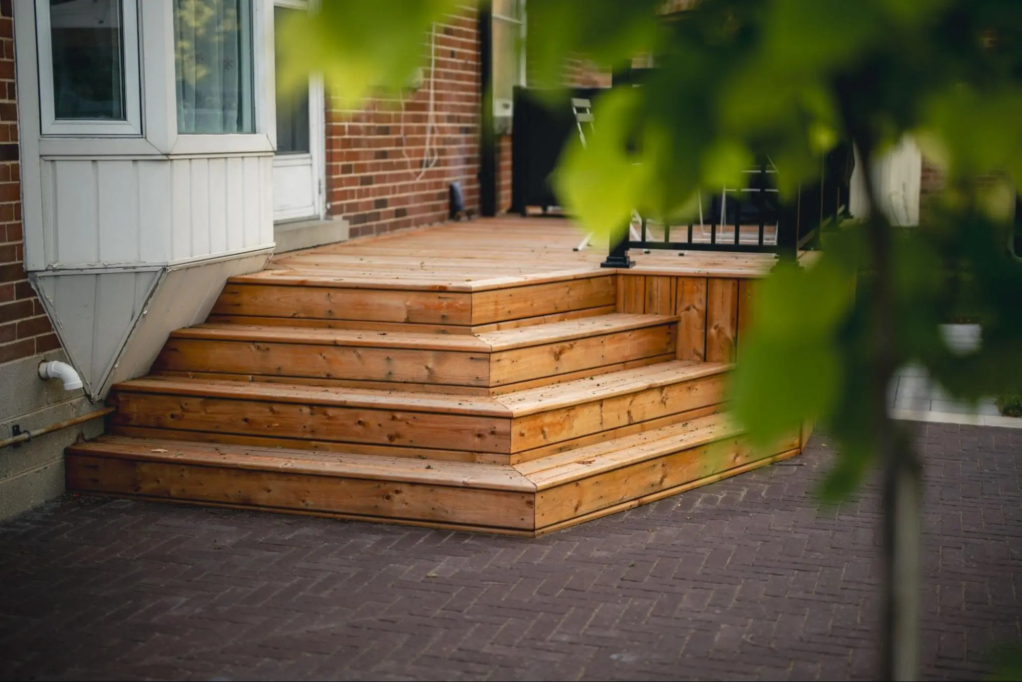 The patio, planting bed, and front yard details