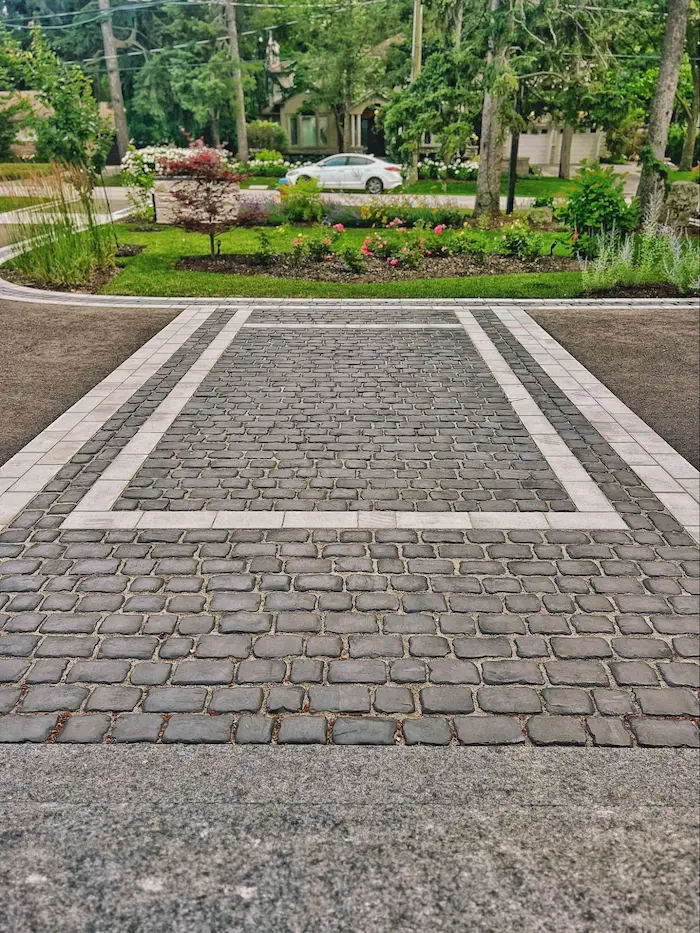 Wide front walkway and entry steps leading to the front door of a custom home